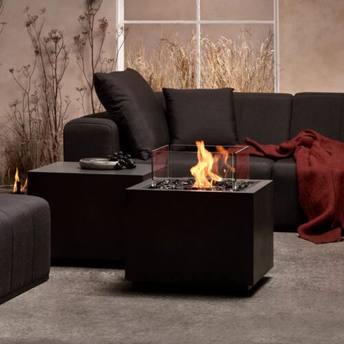 Sidecar 24 Fire Pit Table in graphite finish styled in a modern living room